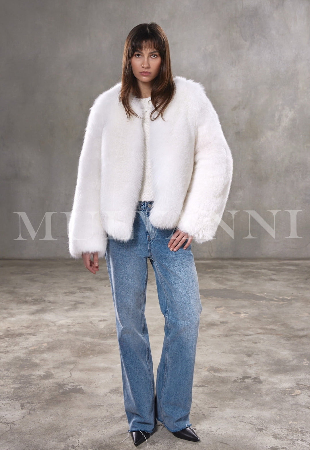 Styled in a plush Arctic fox fur coat, woman exudes chic elegance with the voluminous silhouette and soft satin-lined finish.