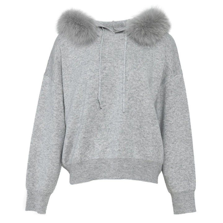 A luxurious cashmere wool set featuring a sweater with a soft fox fur trim and matching trousers. The set combines comfort and elegance, making it a cozy yet stylish option for cooler days.