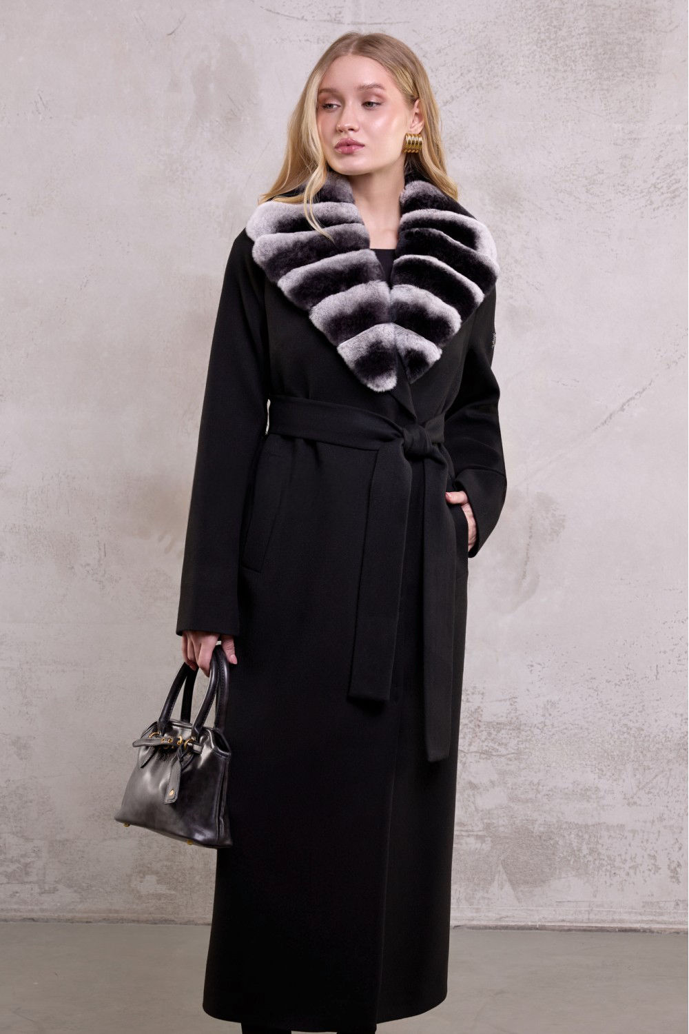 Woman wearing a refined black wool coat with luxurious chinchilla-shade rex rabbit fur collar for a modern, elegant look.