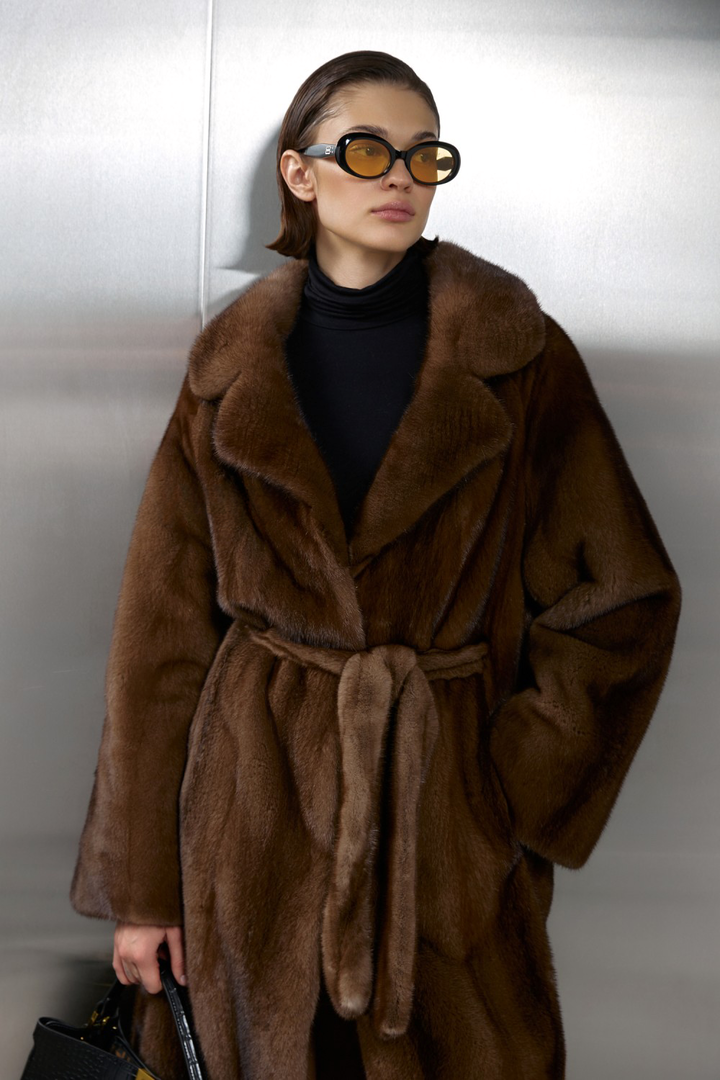 Model in a luxurious long genuine brown mink fur coat, showcasing elegance and warmth with a stylish belt.