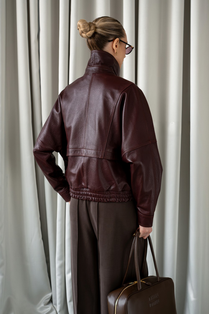 Chic woman in premium leather outerwear and minimalist accessories, highlighting MULVANNI’s elevated everyday style.