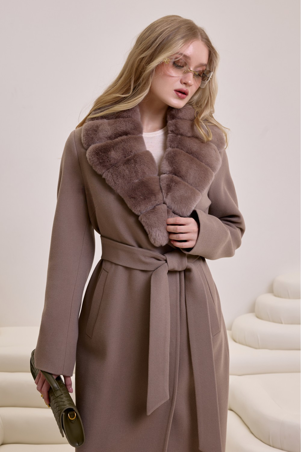 Model showcases a luxurious taupe wool coat trimmed with ultra-soft rex rabbit fur for refined cold-weather style.