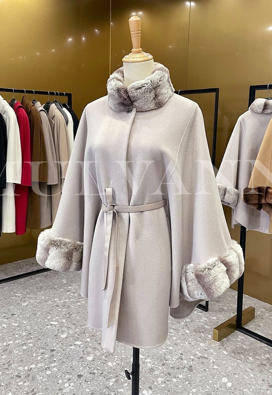 Elegant women’s cashmere cape with rex rabbit fur, showcasing high-quality fabrics inspired by Loro Piana. 
