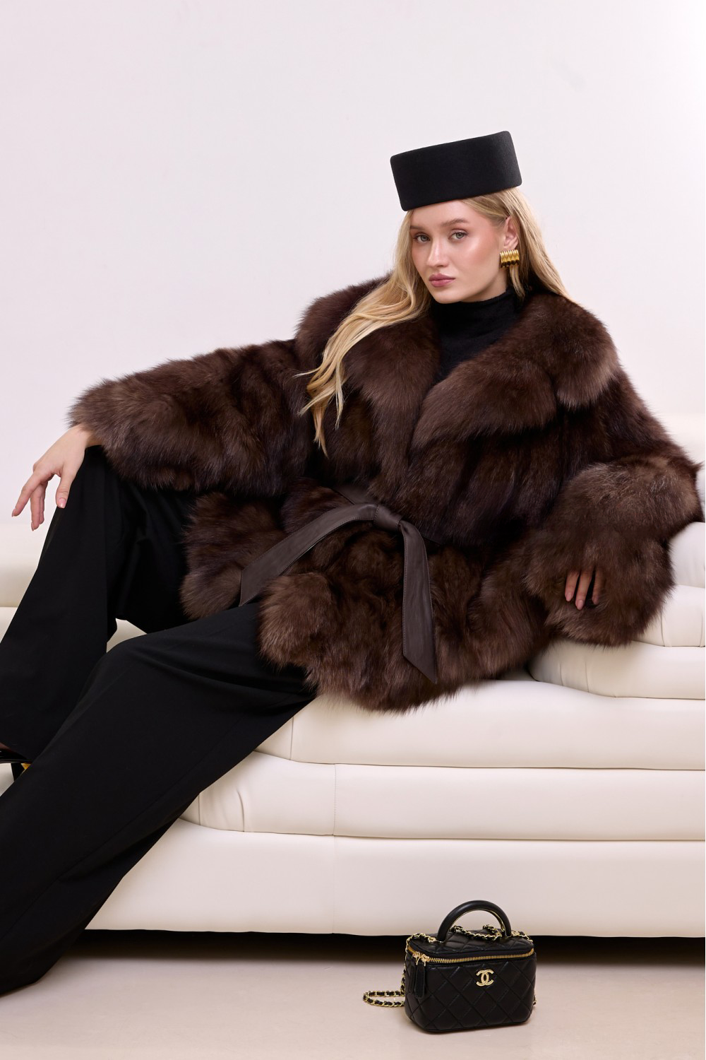 Luxurious fox fur coat with structured tailoring and a soft leather belt, blending timeless glamour with modern sophistication.
