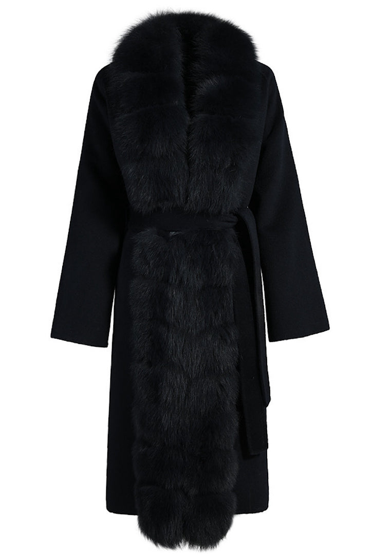 Black cashmere coat with voluminous fox fur collar, combining luxury materials and timeless design.