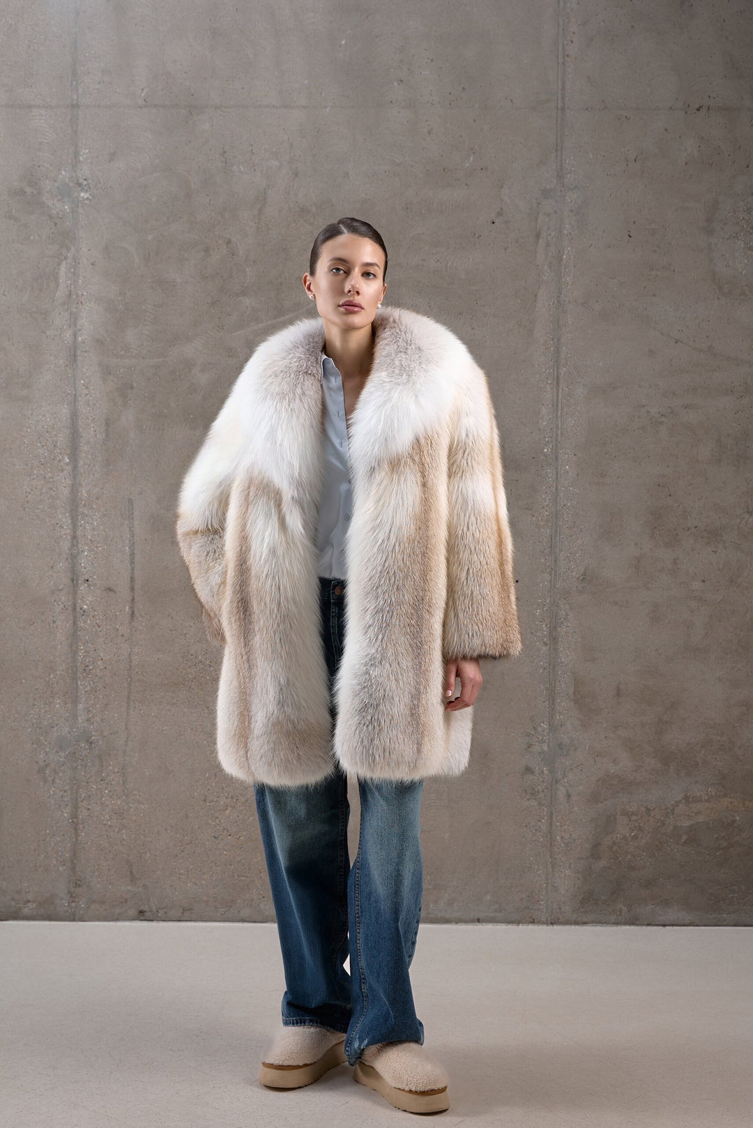 A woman models an elegant full pelt Gold Crossed Fox Fur Coat, handcrafted from genuine fur with striking natural tones and plush volume.