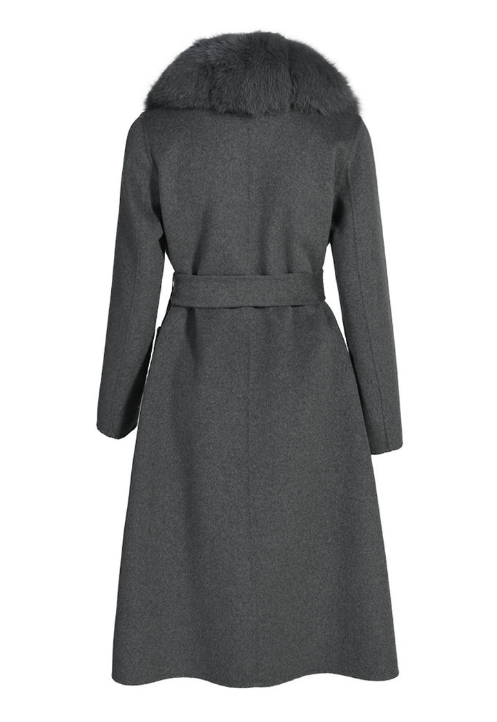 Structured grey cashmere coat with a flawless fit, waist-cinching belt, and cascading grey fox fur trim that enhances its timeless design.