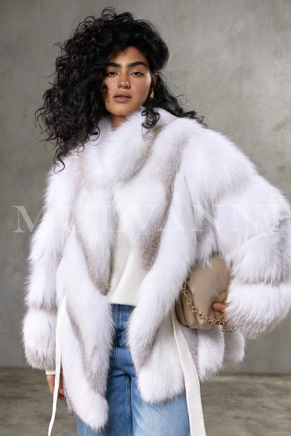 Draped in an elegant crossed Arctic fox fur coat, a woman displays a sophisticated silhouette crafted from plush fur panels, perfectly combining warmth and high fashion without a hood.