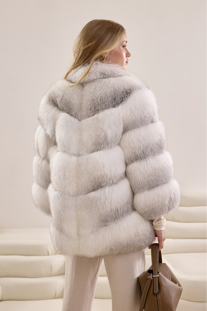 Elegant winter look featuring a modern silhouette coat made from genuine Arctic Crossed fox fur panels.
