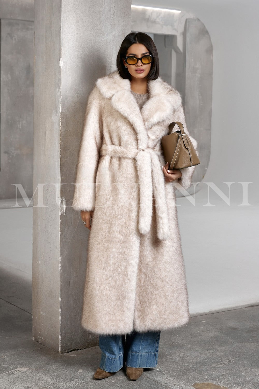 A woman pairs her cozy faux fur coat with casual wear, creating a fashionable yet approachable cold-weather look.