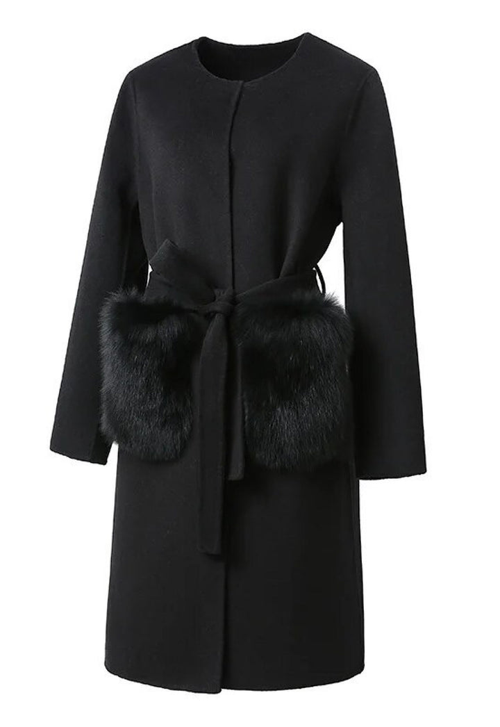 An elegant black cashmere coat adorned with plush fur pockets, showcasing a classic silhouette. The coat’s high-quality fabric and refined details make it a stylish choice for winter outings.