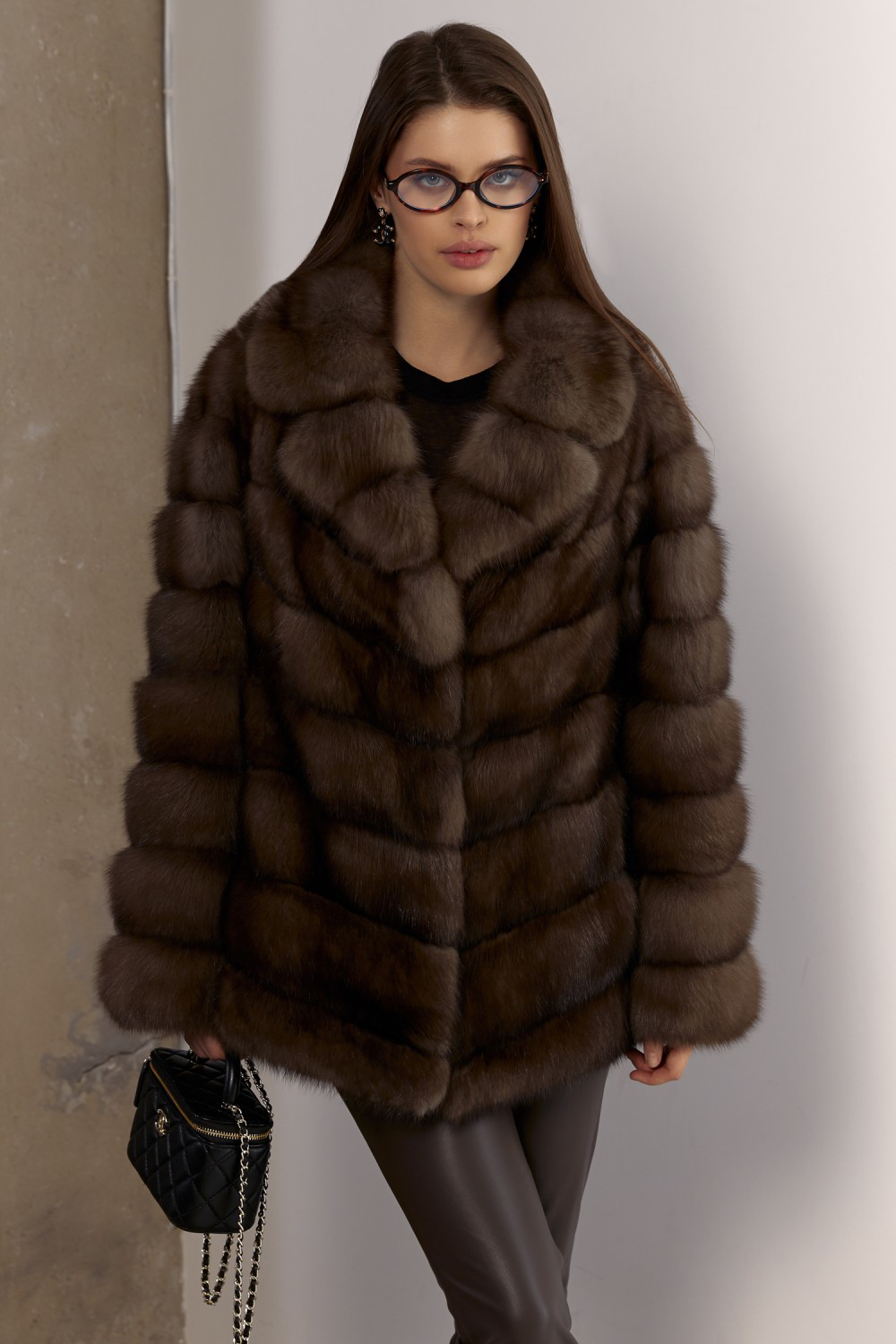 Woman in short sable fur coat, exuding timeless winter luxury.