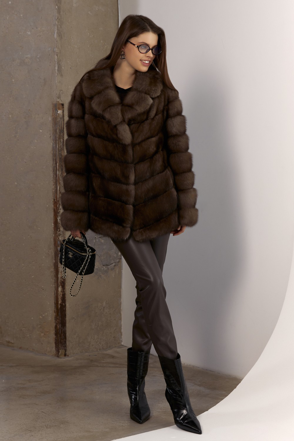 Elegant short brown sable coat styled for chic cold-weather fashion.
