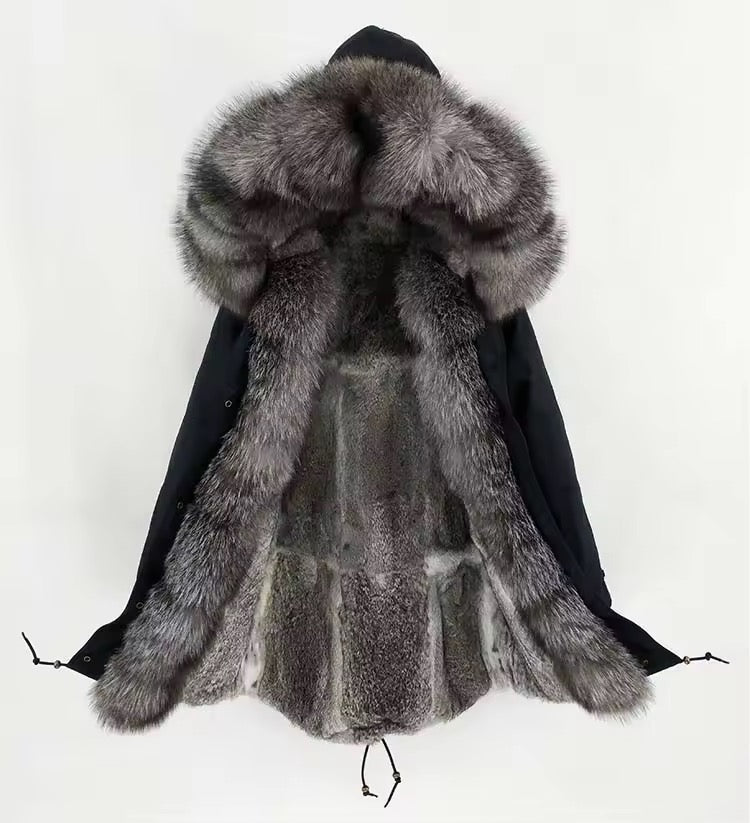 Black technical parka featuring a plush fox fur hood trim that can be removed, front zip and snap closures, and a fishtail hem for contemporary styling.