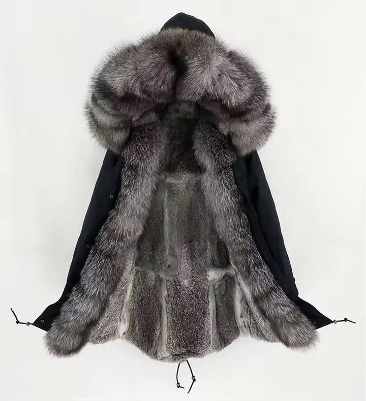 Black technical parka featuring a plush fox fur hood trim that can be removed, front zip and snap closures, and a fishtail hem for contemporary styling.
