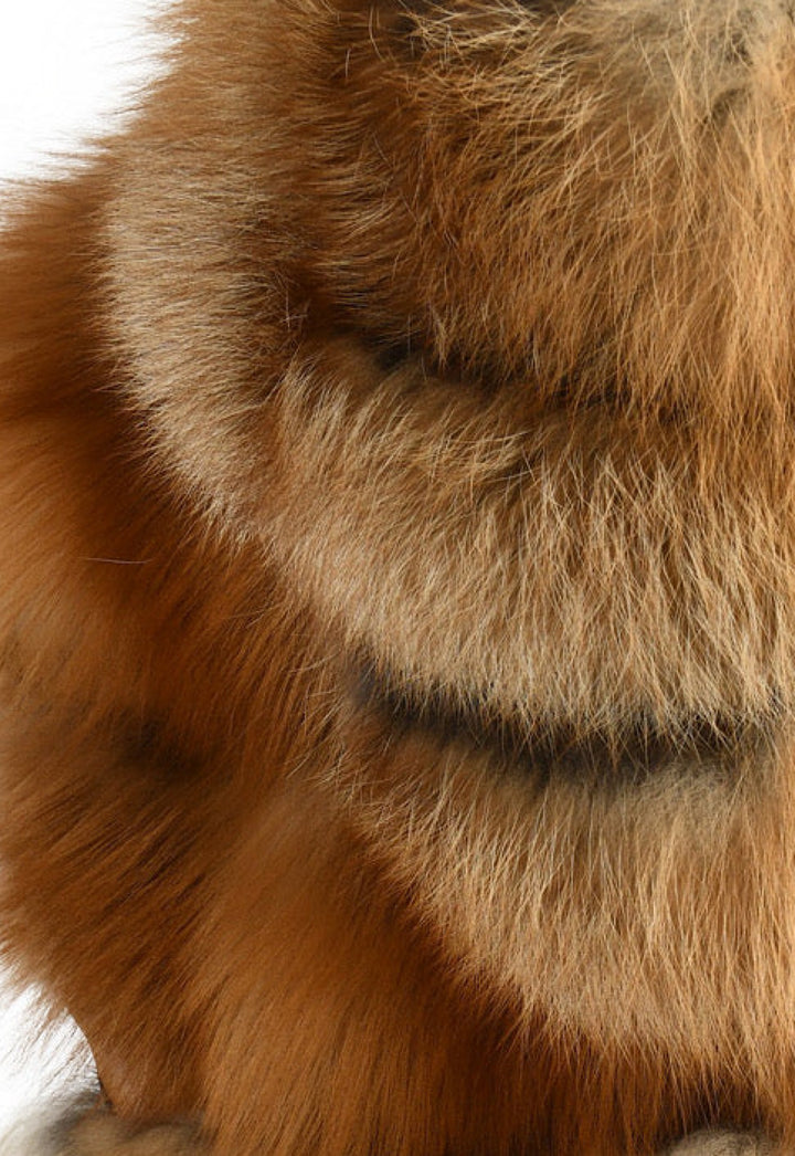 Fluffy and warm cropped fox fur vest with a cozy hood, made from premium red fur and ideal for arctic conditions.