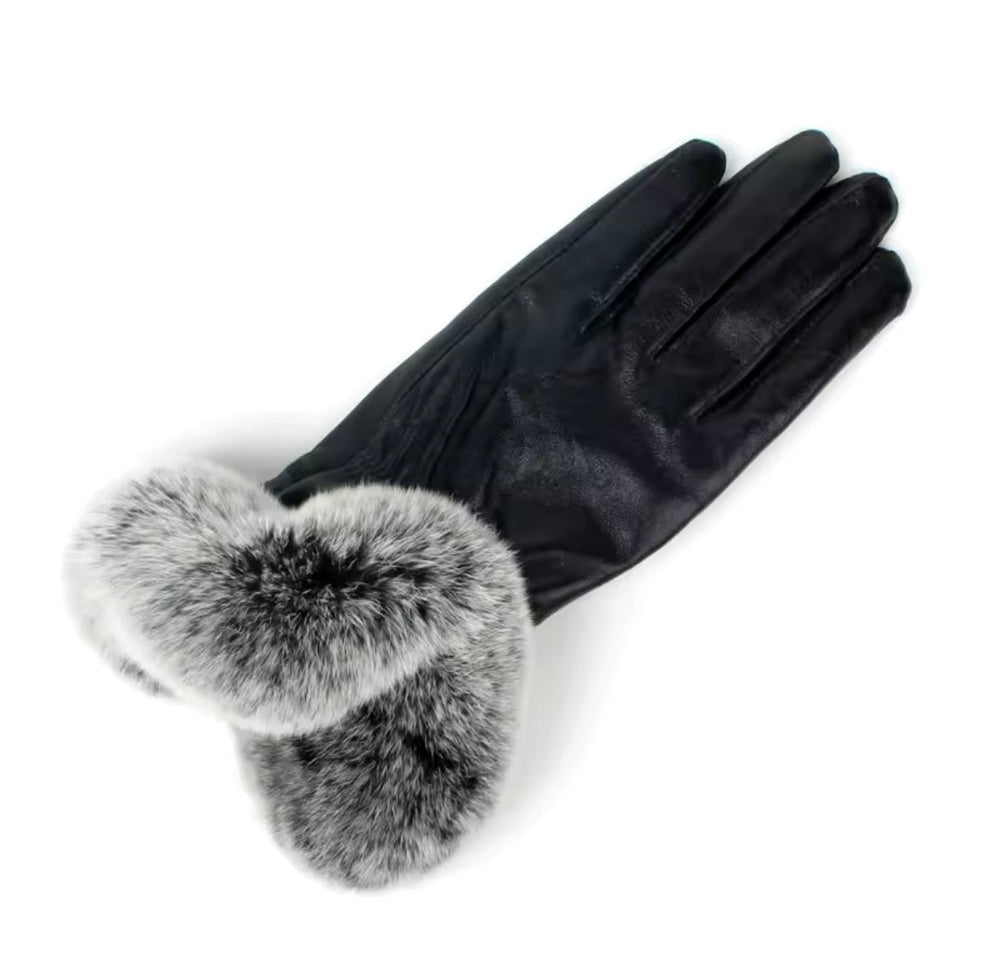 Sleek genuine leather gloves accented with fluffy fox fur cuffs, perfect for cold weather sophistication.
