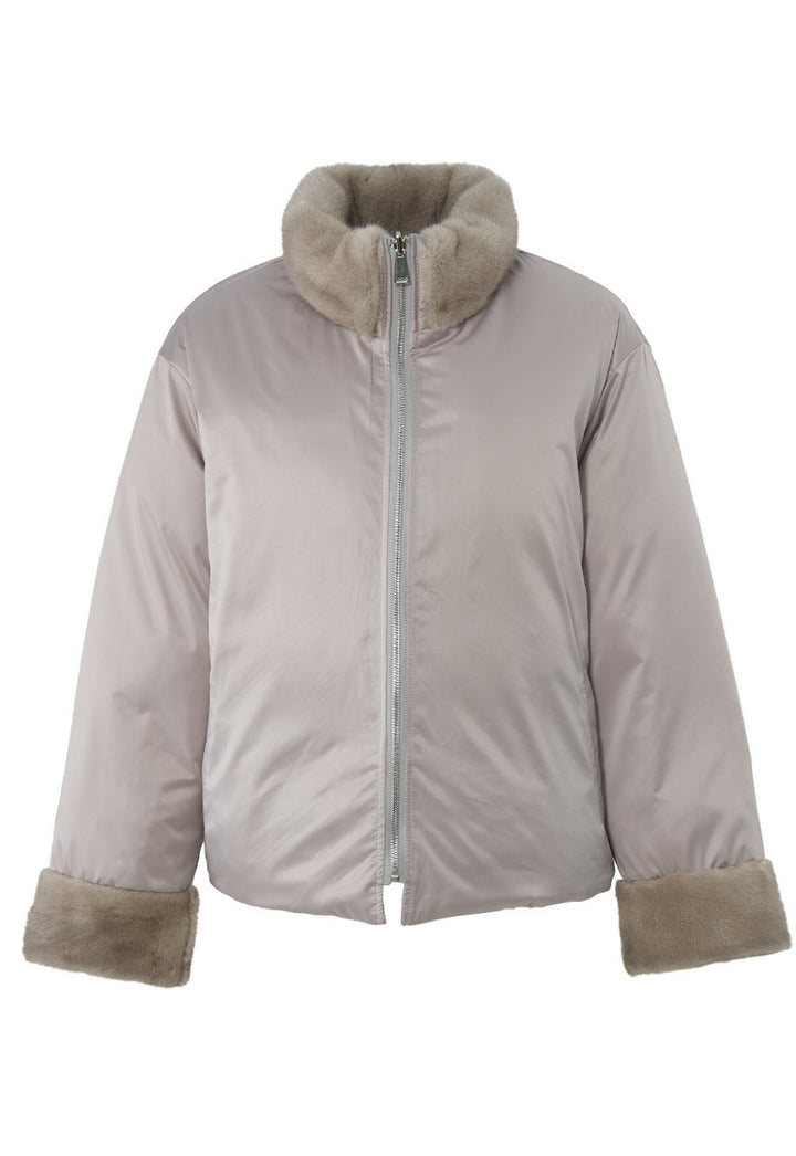 Close-up of a double-face down jacket, showing the contrast between the smooth wool exterior and the rich mink fur trim.