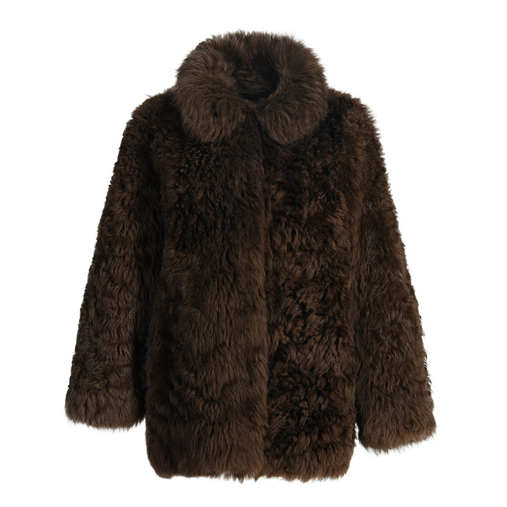 Cozy and elegant brown shearling coat with natural textured fabric, perfect for stylish warmth during colder days.