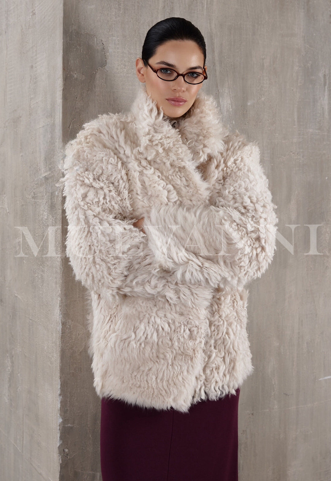 Women's short beige shearling coat, featuring a plush texture and a relaxed, casual fit. The coat has a cropped length, broad lapels, and a simple button-up front, blending comfort with effortless style.
