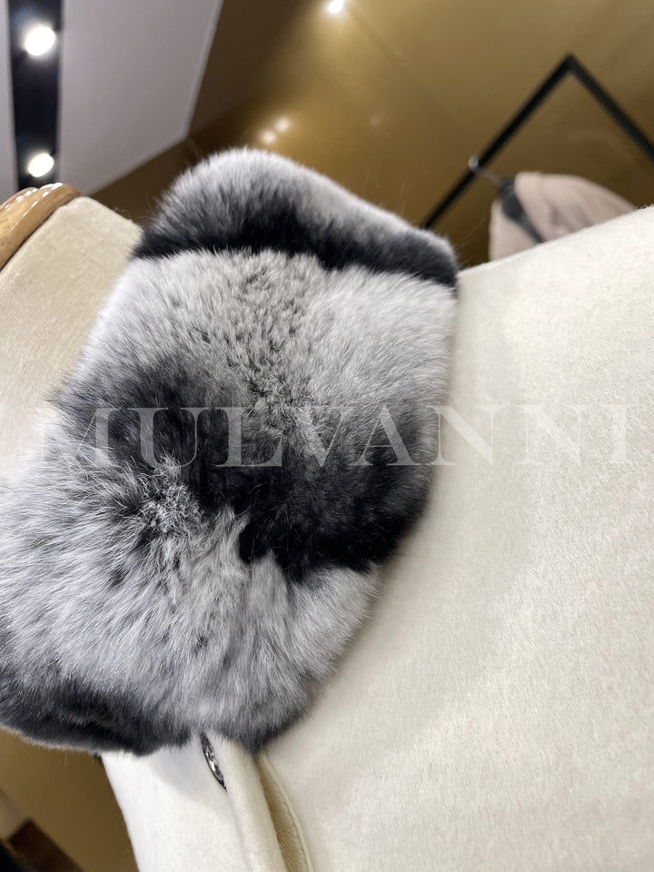 Close-up of structured funnel neckline with soft and delicate rex rabbit fur on a women cashmere cape, showcasing high-quality fabrics used.