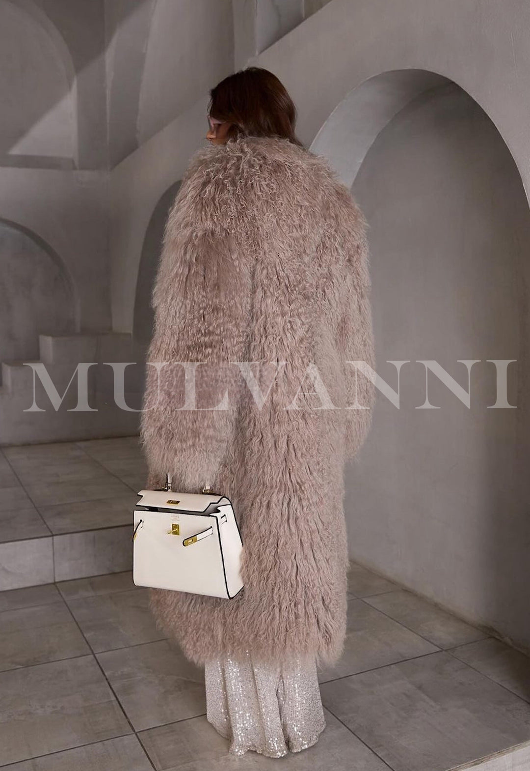 Woman dressed in a chic light brown Mongolian fur coat, a trendy winter look.