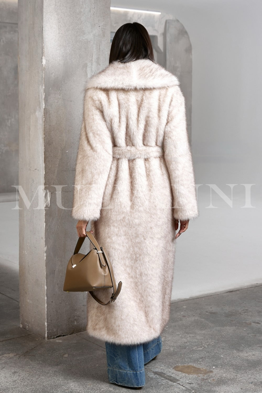 Woman steps out in a voluminous faux fur coat, styled with casual flair for warmth, texture, and effortless cool.