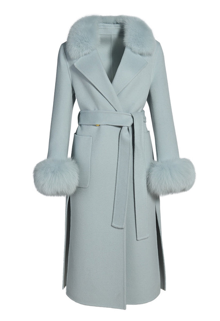 Pastel blue cashmere coat featuring a wrap silhouette with a wide shawl collar trimmed with plush, detachable genuine fox fur, combining elegance and warmth.