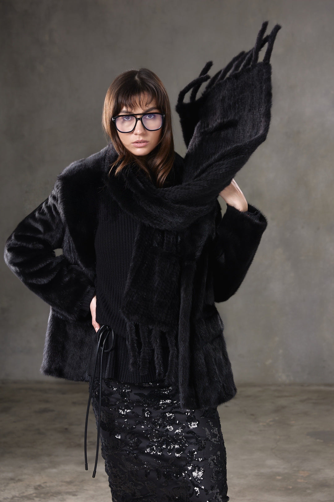 Luxurious black mink fur scarf with a soft, plush texture and elegant sheen, perfect for adding warmth and sophistication to any outfit.