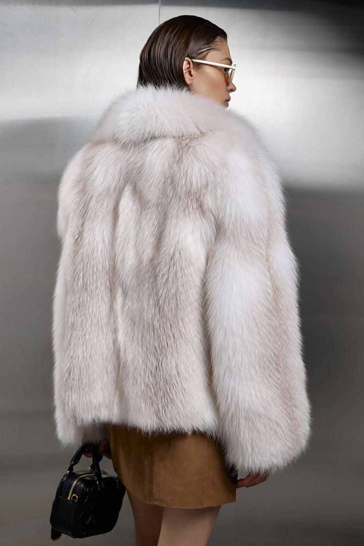 Draped in a plush Crossed Fox Fur coat, a woman showcases timeless elegance designed to withstand arctic temperatures as low as -25ºC.