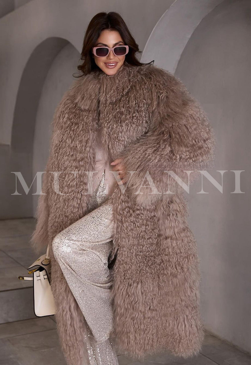 Stylish woman in a long light brown fur coat showcasing winter fashion and sunglasses. 