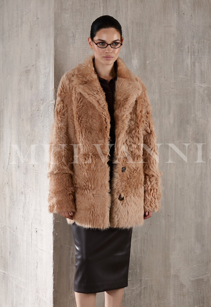  Short camel shearling coat for women, with a soft, fluffy interior and a tailored fit. The coat has large buttons, a wide collar, and hits just above the hips, creating a warm yet fashionable look.