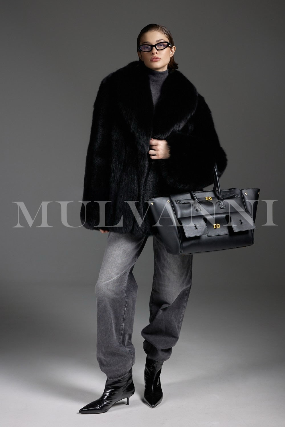 Dressed in a sumptuous fox fur coat, a woman displays elegant sophistication, the natural luster of the plush fur creating a regal winter look.