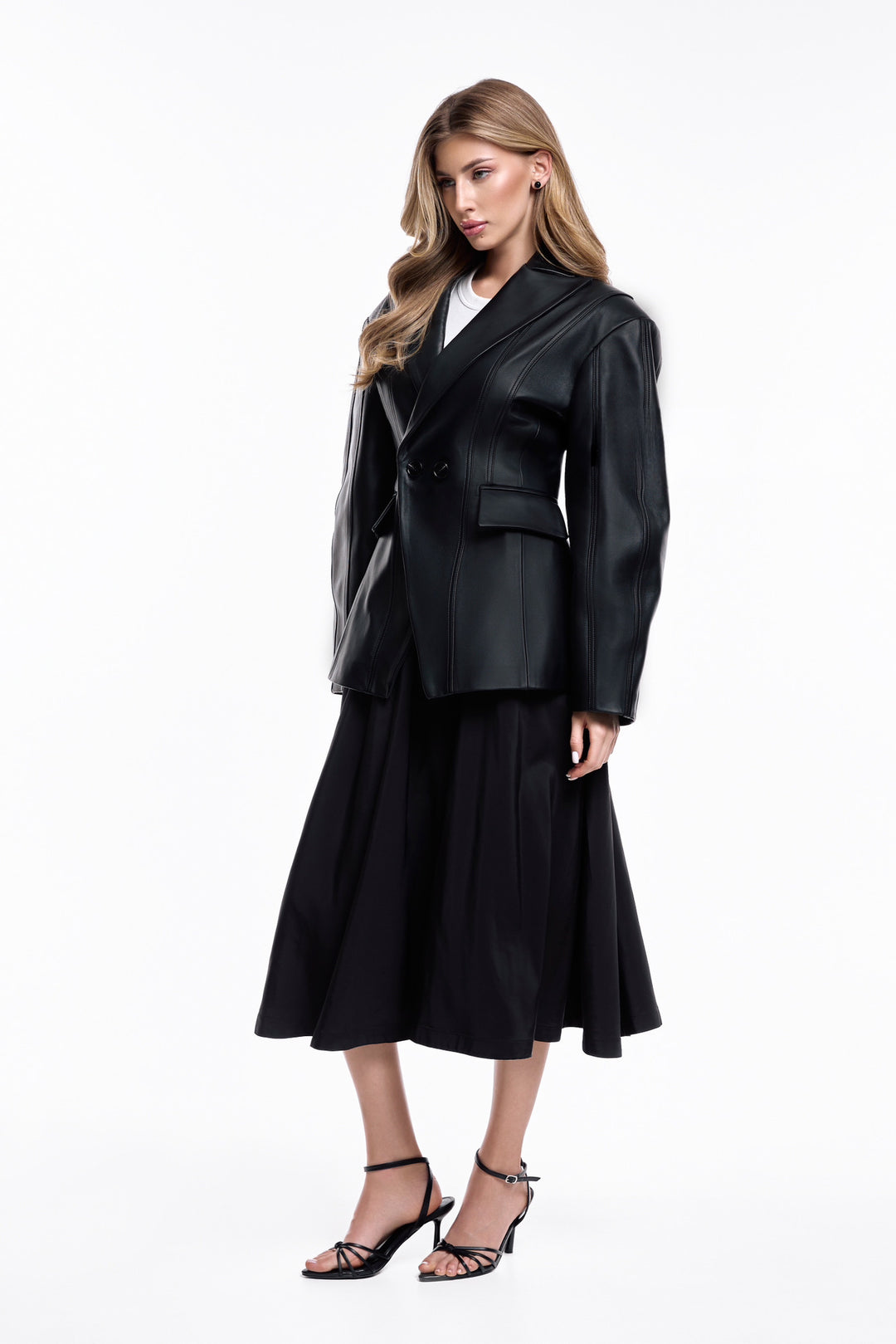 A woman wearing a sophisticated black leather blazer, crafted from supple leather and tailored to highlight the feminine shape, perfect for both professional wear and chic, casual moments.