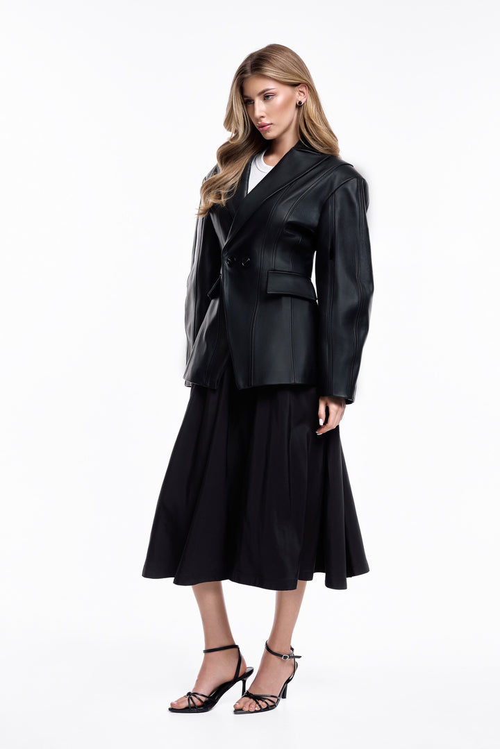 A woman wearing a sophisticated black leather blazer, crafted from supple leather and tailored to highlight the feminine shape, perfect for both professional wear and chic, casual moments.