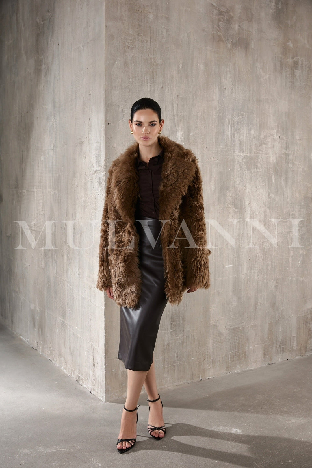 Woman gracefully wearing a rich brown chestnut shearling coat, blending exceptional warmth with a luxurious, timeless design perfect for chilly days.