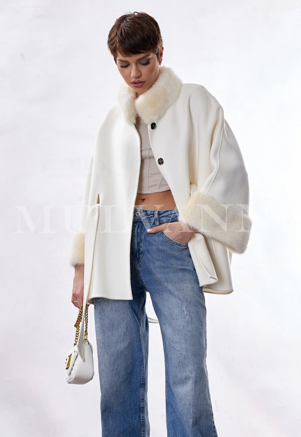 Model showcases a classic-cut double-face cashmere coat featuring a refined funnel neck finished with delicate mink fur, ideal for sophisticated, formal occasions.