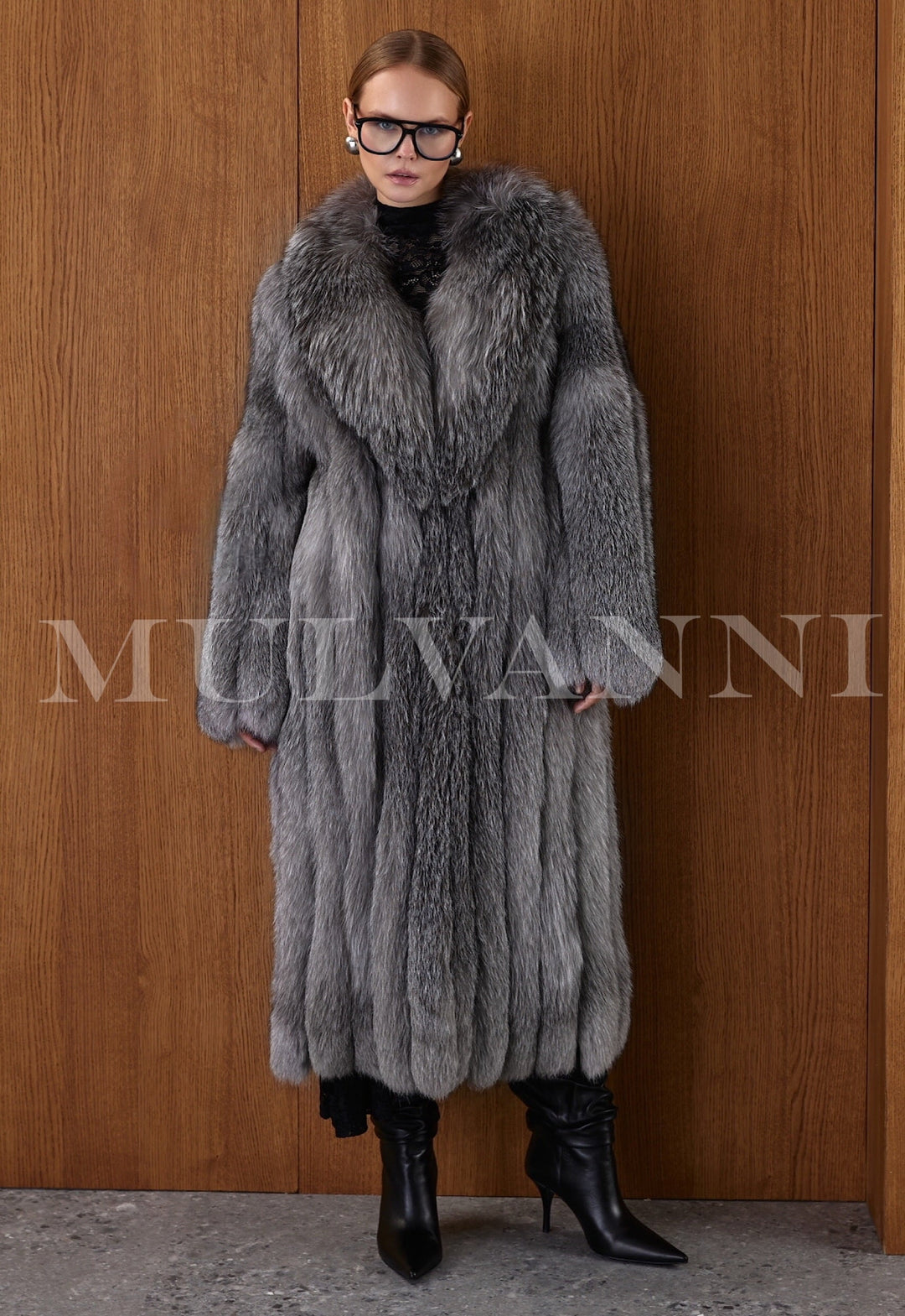 Full-body view of a woman in a Silver Frost Fox Fur coat, the dramatic length and soft density creating a high-fashion winter statement.