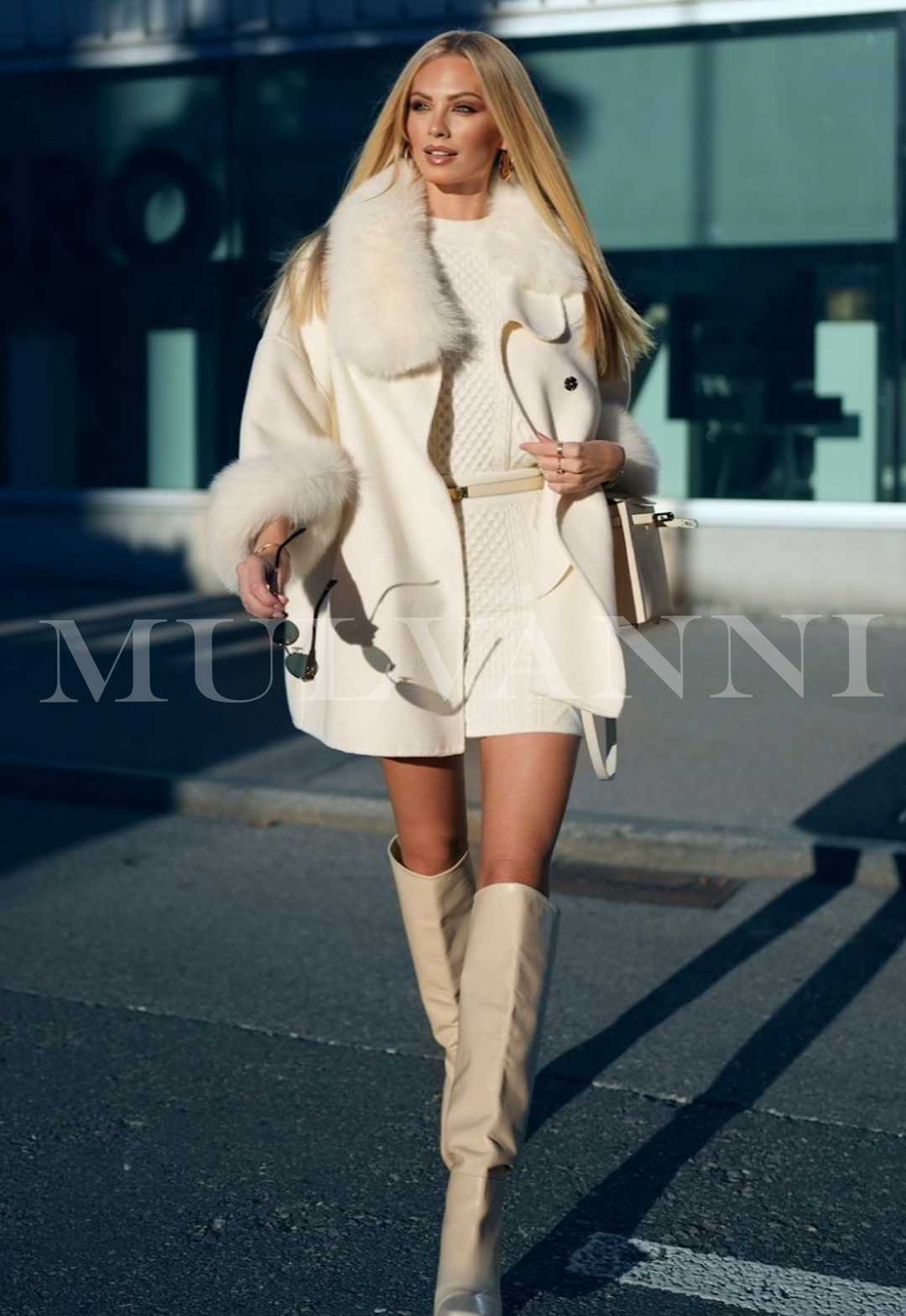 Woman wearing an Off White Oversized Cashmere Coat with Fox Fur walking outdoors, showcasing elegant winter fashion style.