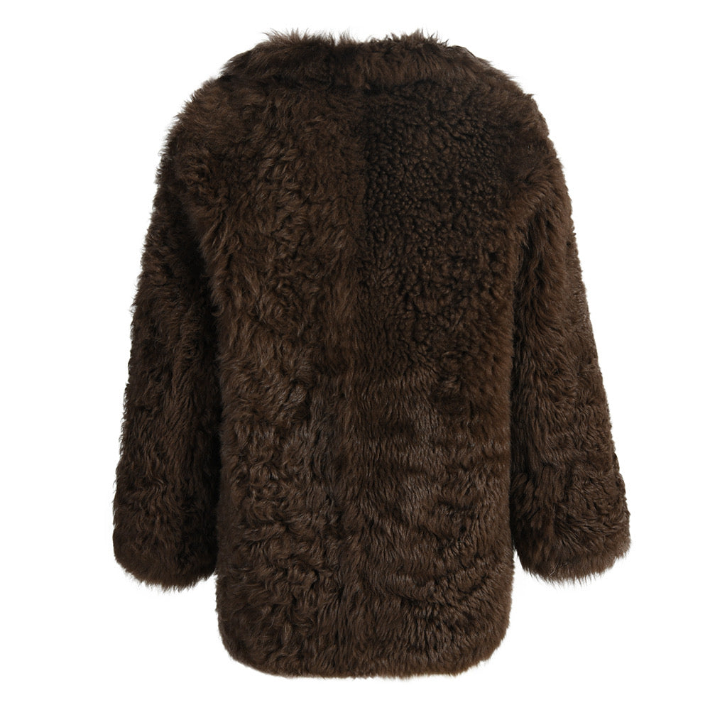 Timeless brown shearling coat with plush, warm fabric and natural texture, designed for a chic winter look.