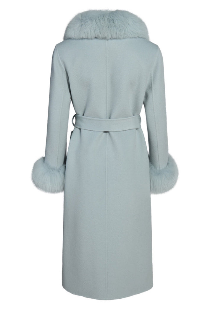 Back view of the pastel blue cashmere coat showing smooth fabric finish and genuine fox fur trim along the collar and cuffs.