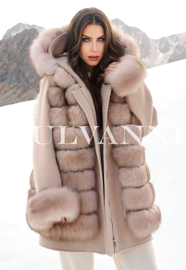 Woman wearing a Reversible Merino Wool Parka with Luxury Fox Fur Vest in snowy mountains, limited edition luxury designer coat.