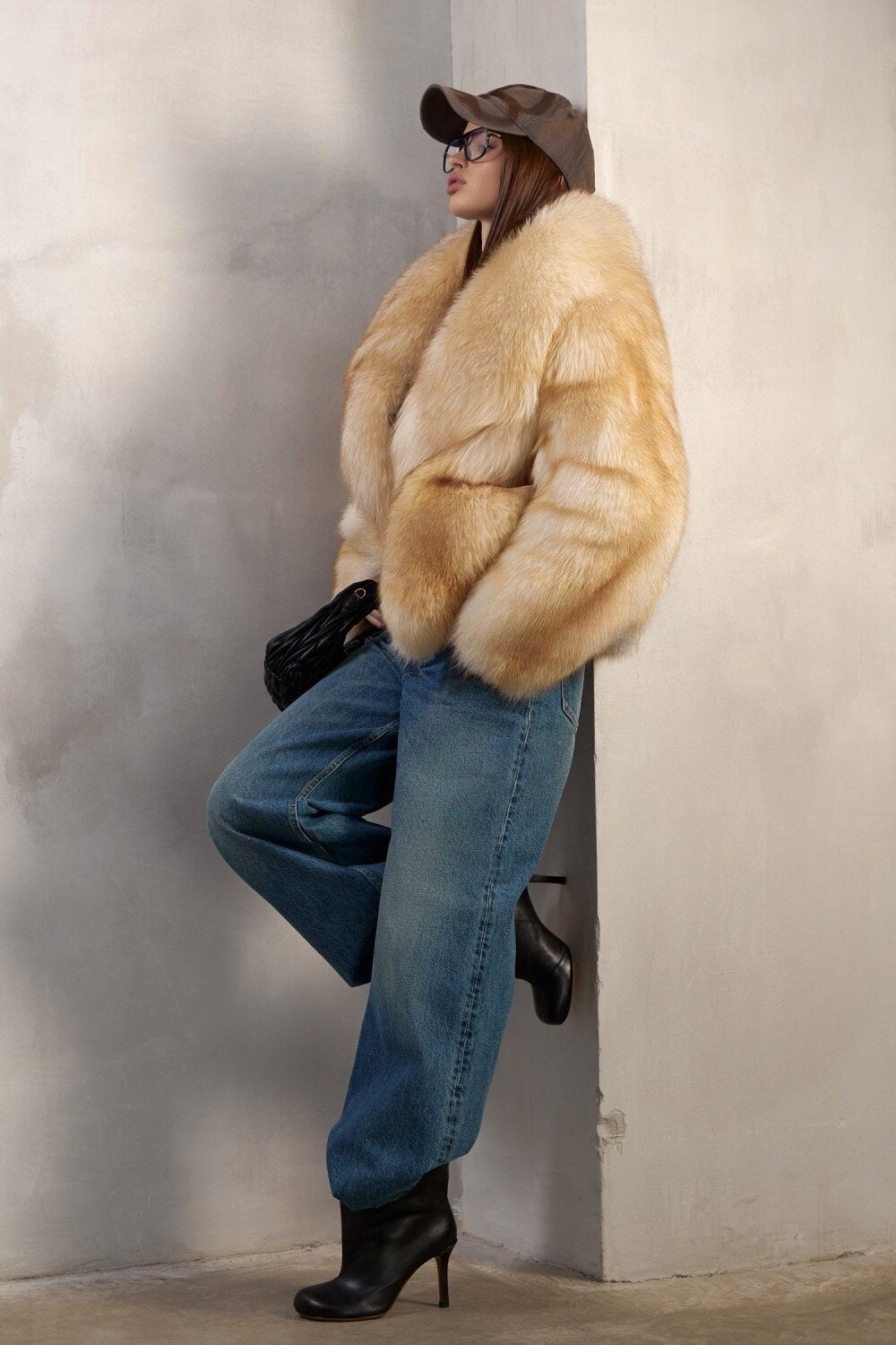 A woman models an opulent gold fox fur coat crafted from full pelts, combining timeless elegance with unmatched warmth and visual impact.