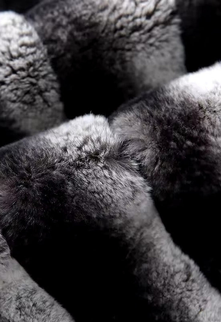 Close-up of the chinchilla-effect Rex Rabbit fur trim on black cashmere, emphasizing the soft gradient tones and velvety texture for a luxurious finish.