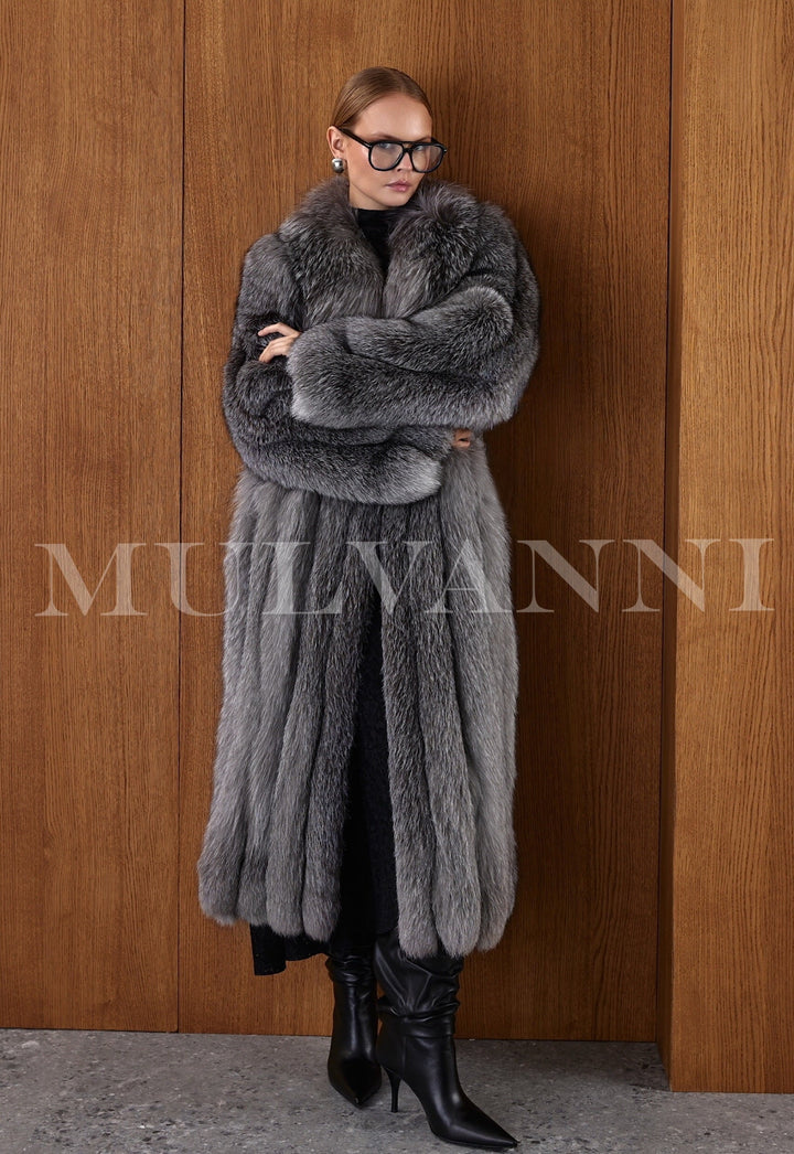 Elegant close-up of the coat worn by a woman, highlighting the intricate variation in the natural fur tones and the plush, flowing finish.