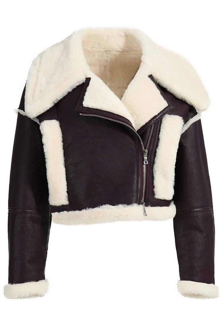 cropped black shearling leather jacket, offering a blend of warmth and urban style.