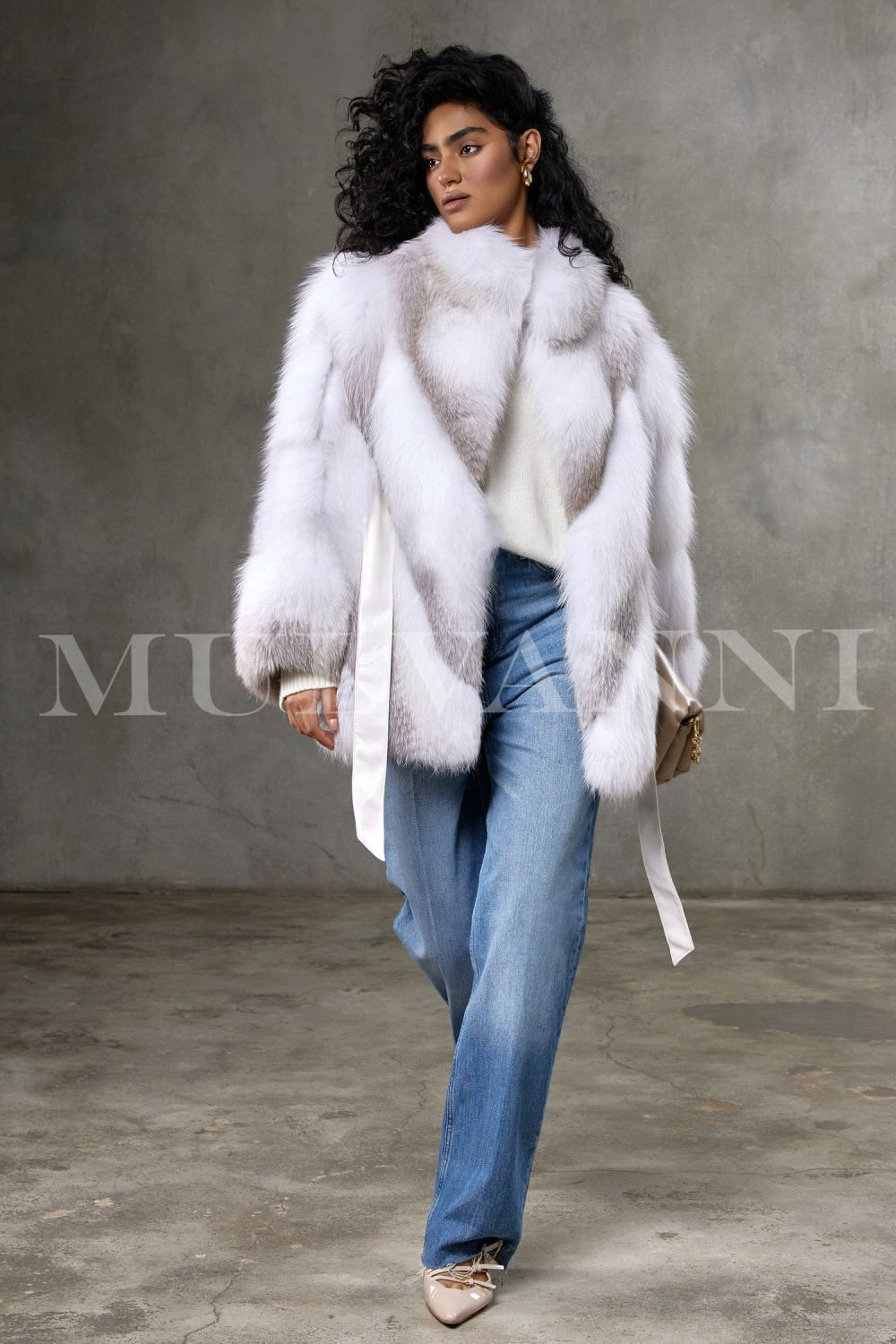 This luxurious crossed Arctic fox fur coat, worn by a woman, features exquisite craftsmanship and a hoodless, streamlined design that highlights its elegant texture and opulent appeal.