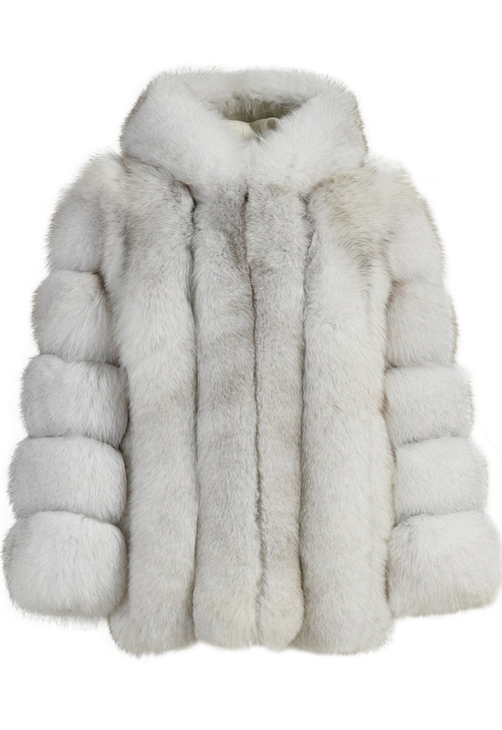 An opulent white fox fur coat with a large hood, showcasing its rich quality and plush feel. The coat combines functionality and high fashion, ideal for staying warm in style