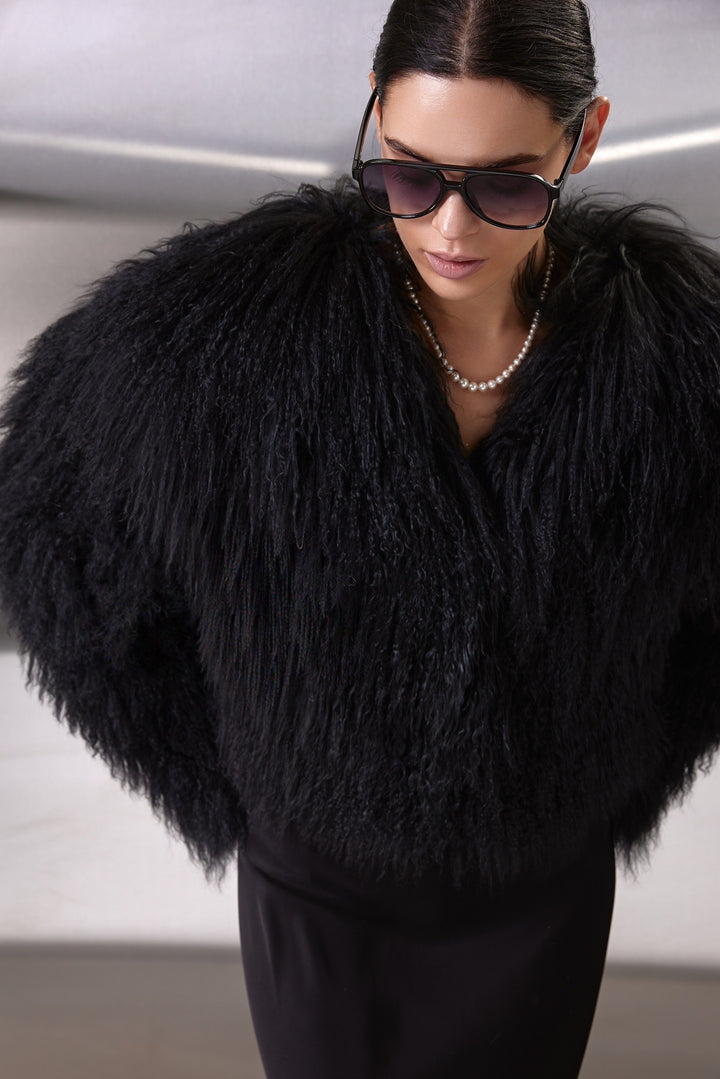 Stylish woman wears the soft, thick Mongolian fur coat, showcasing its seamless design and practical features perfect for winter elegance.