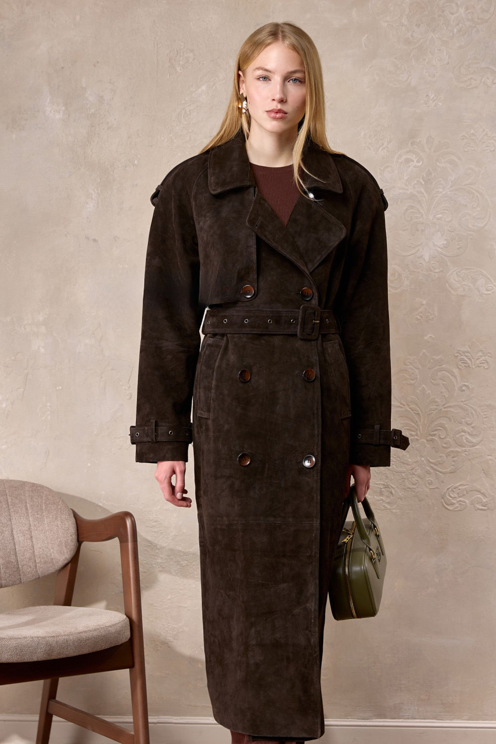 Woman dressed elegantly in the Hatti suede leather trench coat, showcasing its premium suede texture and classic yet contemporary silhouette.